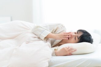 ベッドの中で目覚めた若い女性